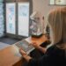 Woman using a tablet at a reception desk.